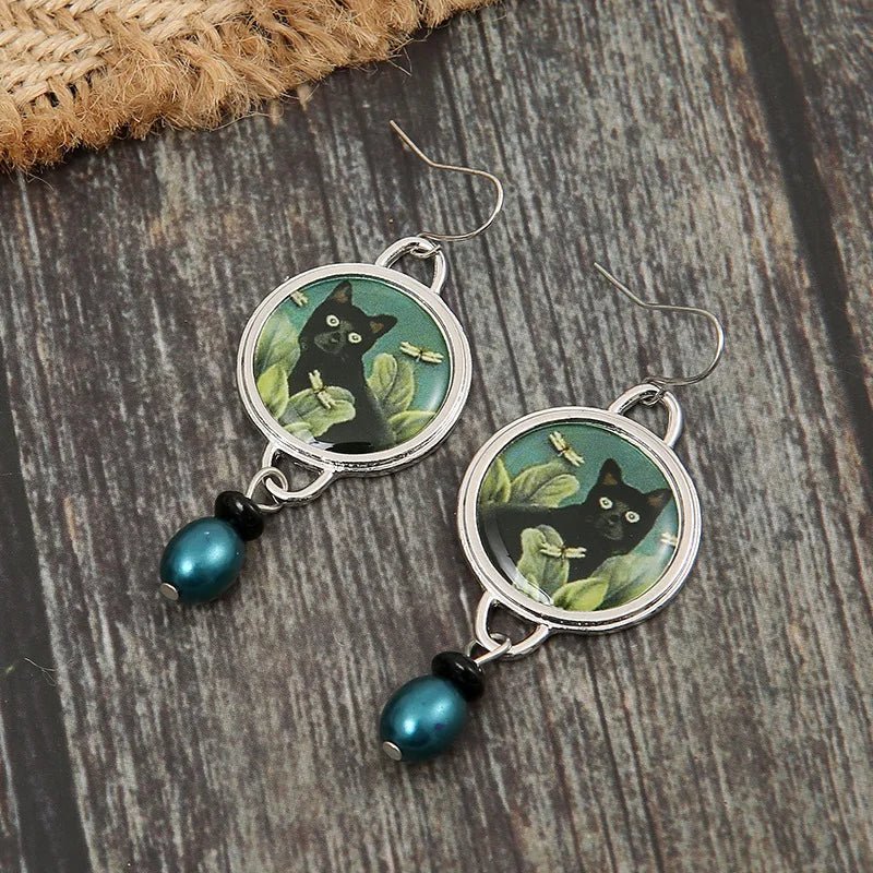 Aretes colgantes vintage con gato negro tropical